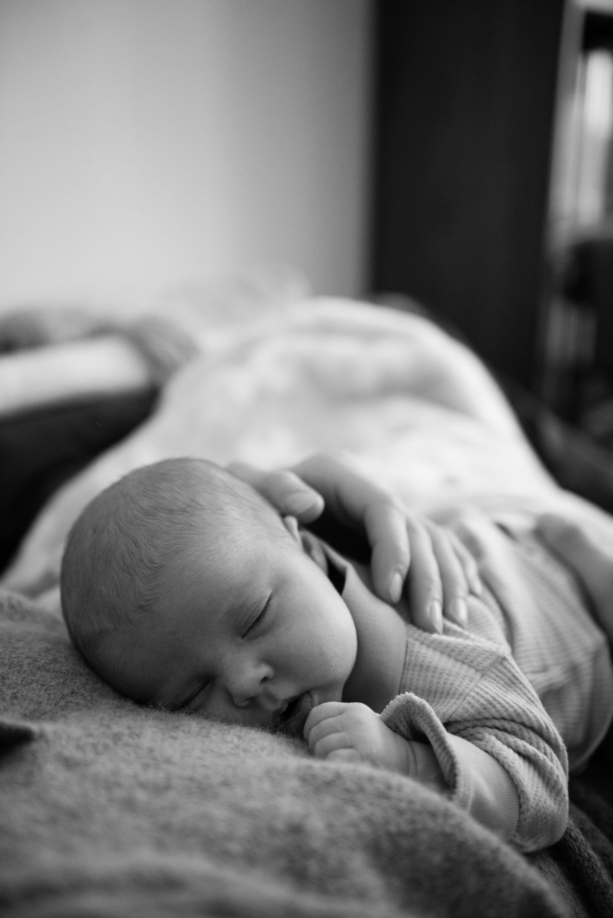 Newborn asleep, in black and white